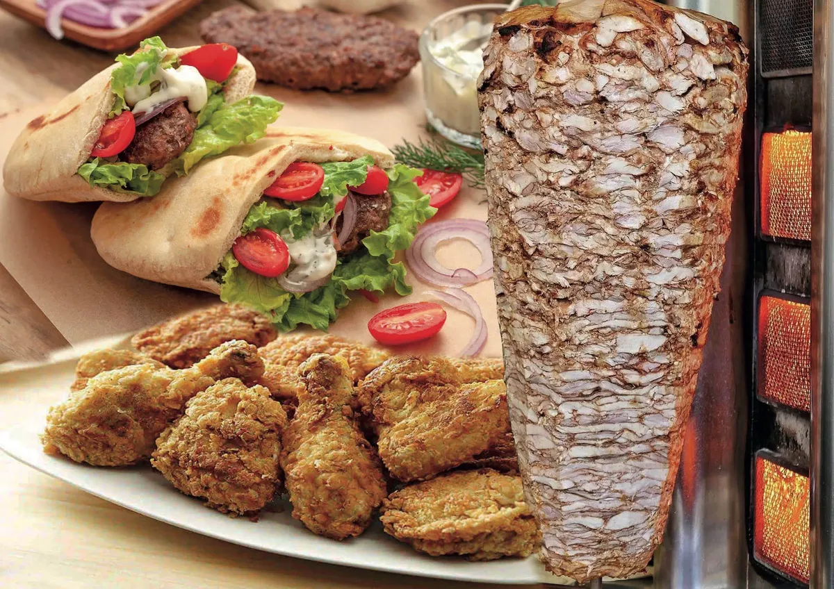 Gyros on pita with tomato and white sauce, a plate of fried chicken and a shawarma cone